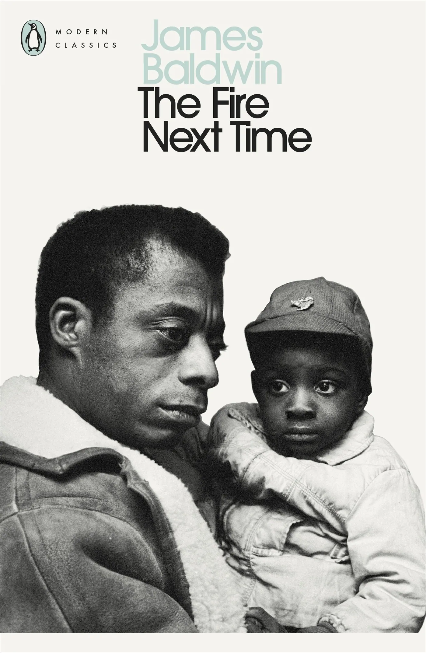 Cover of The Fire Next Time by James Baldwin, Penguin Modern Classics edition, showing Baldwin holding a child.