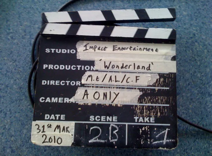 A film clapperboard reading Studio: Impact Entertainment, Production: 'Wonderland', Director: M.E./A.L./C.F., Camera: A Only, Date: 31st Mar 2010, Scene 2B, Take 1.