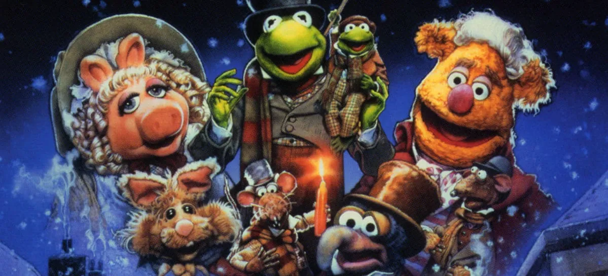Poster art for The Muppet Christmas Carol, with Kermit as Bob Cratchit surrounded by Miss Piggy, Fozzie, Gonzo, and other Muppets in Victorian dress.
