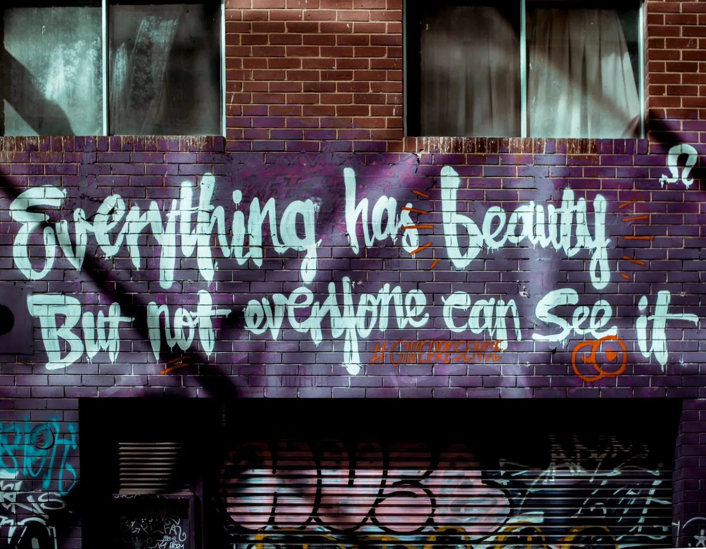 "the only thing you can control is your effort", painted in white letters on a dark brick wall.