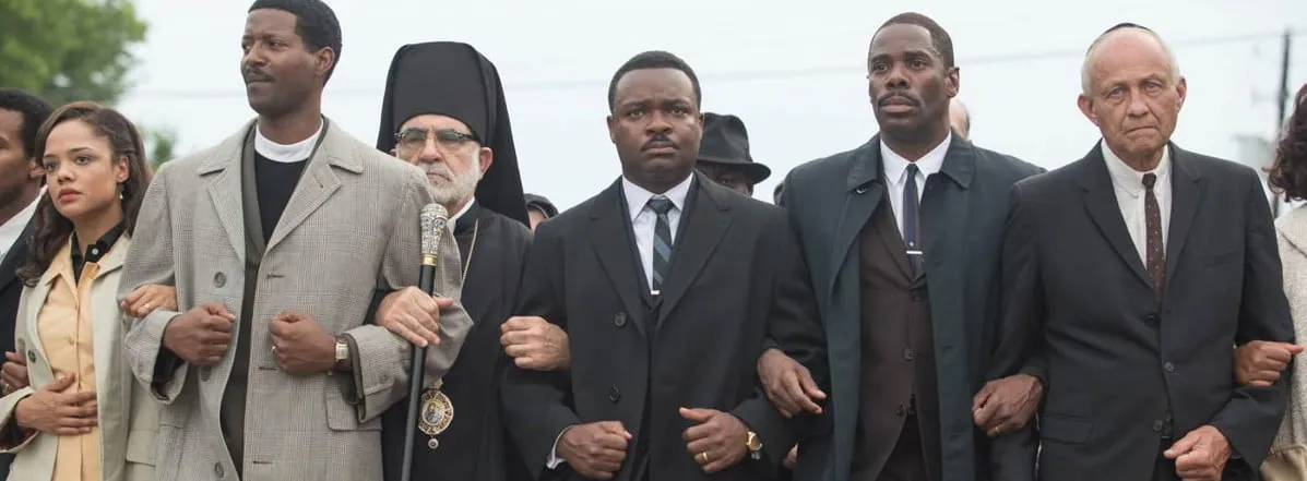 Film still from Selma: Martin Luther King Jr. and fellow marchers walk arm in arm during the civil rights march.