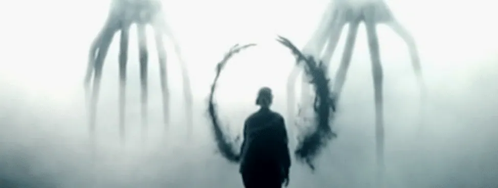 Film still from Arrival: a human silhouette approaches the alien heptapods' portal through fog.