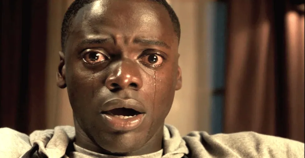 Film still from Get Out: Chris's tearful, terrified expression in the film's iconic close-up.