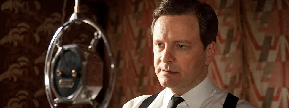Film still from The King's Speech: King George VI, played by Colin Firth, stands before a vintage radio microphone.