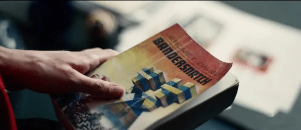Film still from Bandersnatch: a hand holding the in-story gamebook by Jerome F. Davies.