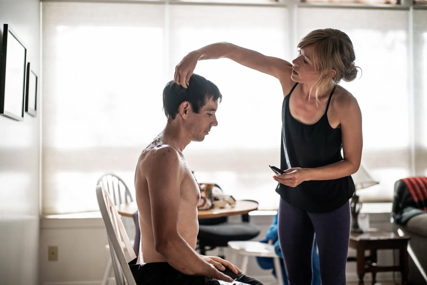 Alex Honnold getting his hair cut outdoors by his girlfriend Sanni McCandless before his free solo attempt of El Capitan. (National Geographic/Jimmy Chin)