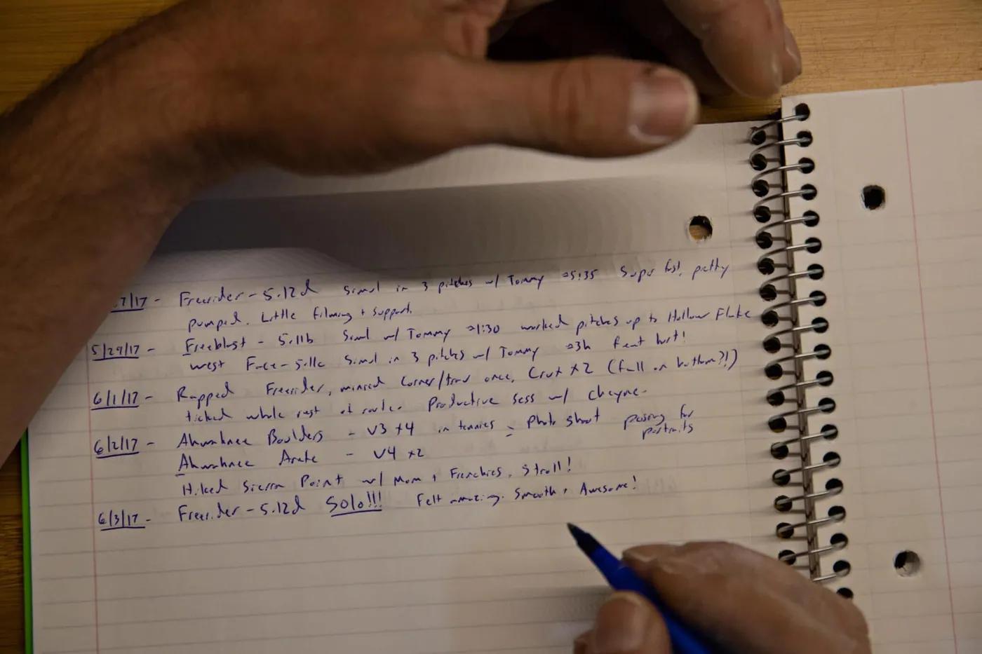 Alex Honnold writing in his climbing journal. (National Geographic/Jimmy Chin)