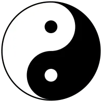 The yin-yang symbol: a circle split by an S-curve into one black and one white half, each half holding a small dot of the opposite colour.