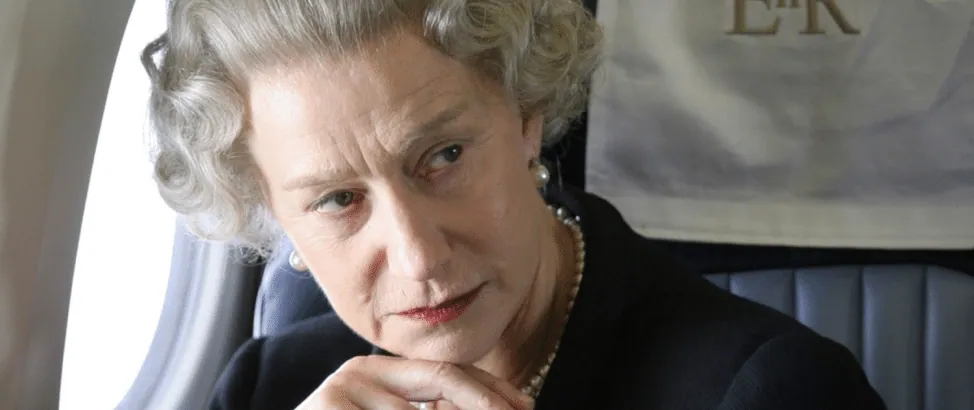 Film still from The Queen: Helen Mirren, as Queen Elizabeth II, sits pensively aboard a plane.