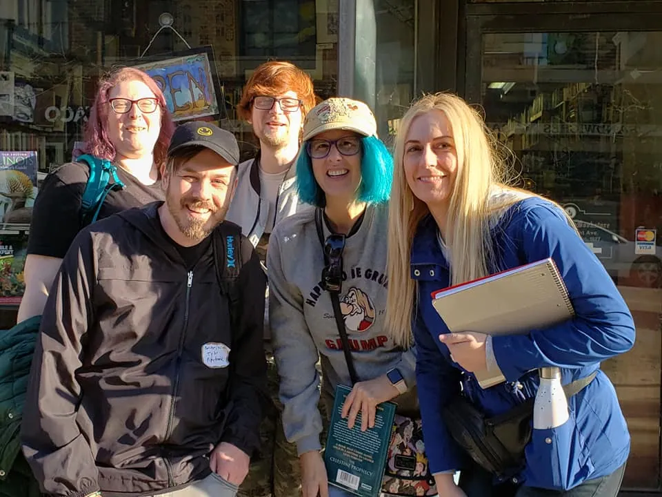 Five attendees posing outside a bookstore at The Sell More Books Show Summit 2019.