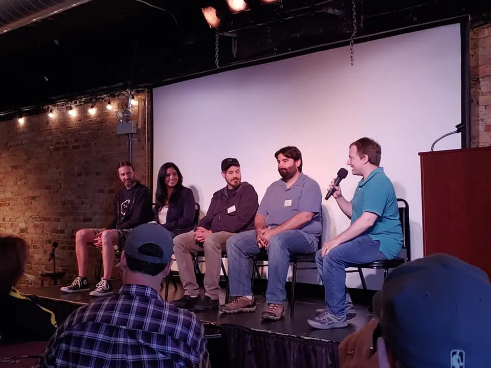 A panel of speakers seated on stage during The Sell More Books Show Summit 2019.