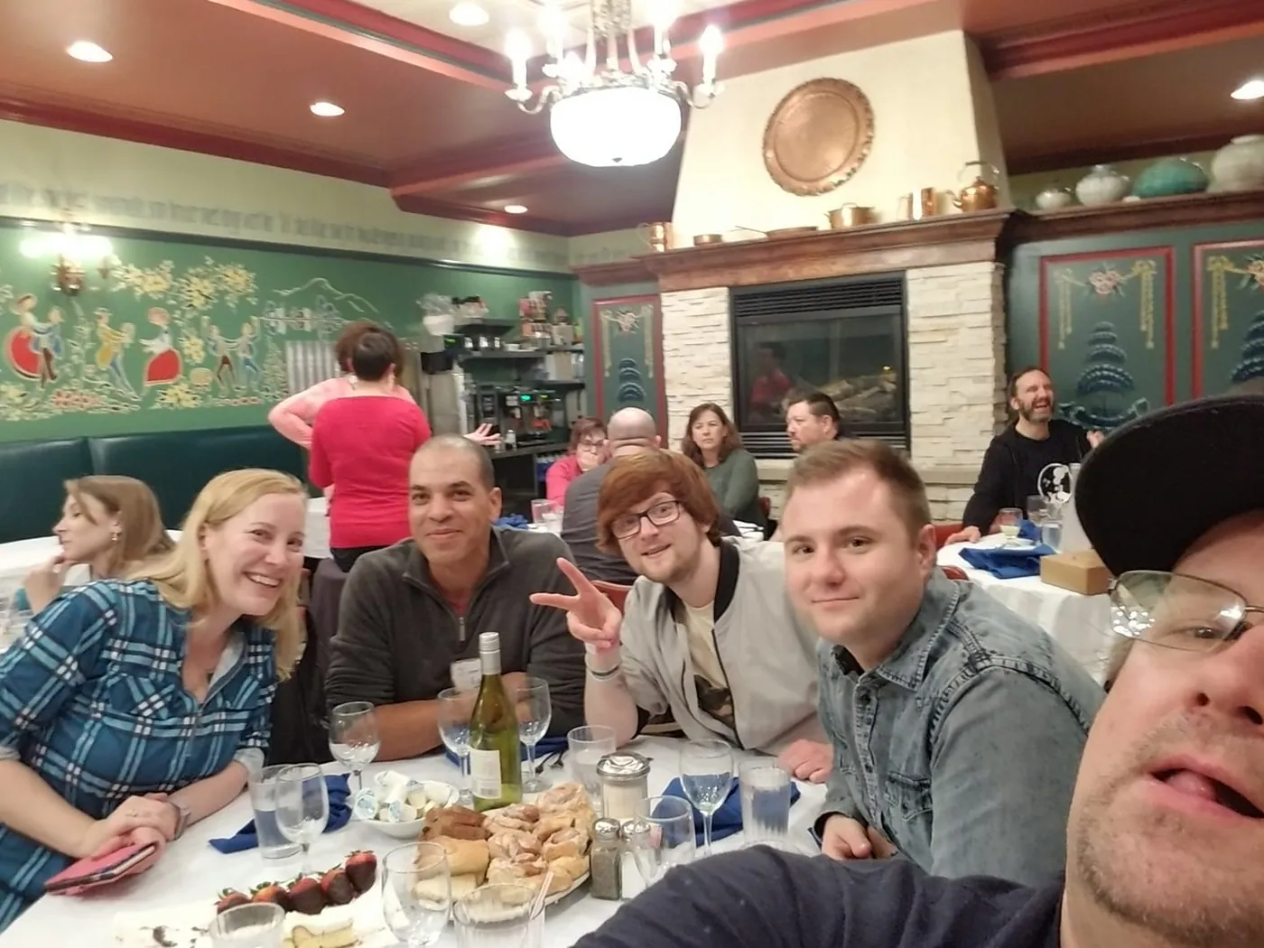 A group selfie at a restaurant dinner during The Sell More Books Show Summit 2019.