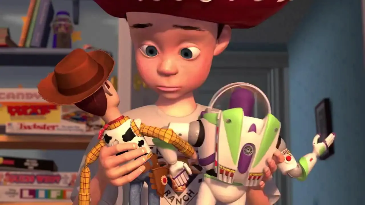 Toy Story's Andy holding Woody and Buzz Lightyear together.