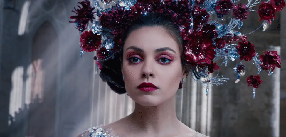 Film still from Jupiter Ascending: Jupiter Jones wears an elaborate crown of dark red flowers and crystal branches.