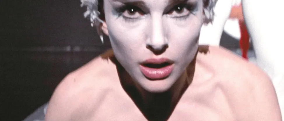 Film still from Black Swan: Nina, in dark swan makeup, stares intensely into the camera.