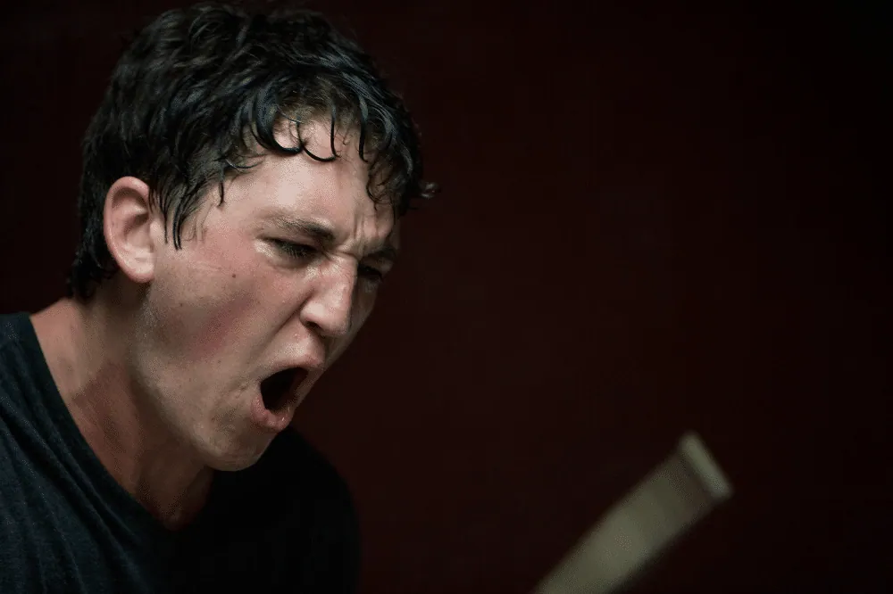 Neiman drumming, sweat-drenched and shouting, near the climax of Whiplash.