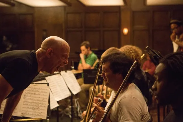 Fletcher shouting into a trombone player's face during a rehearsal in Whiplash.