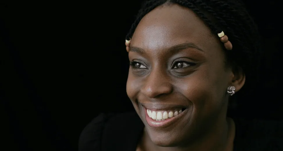 Portrait of author Chimamanda Ngozi Adichie smiling.