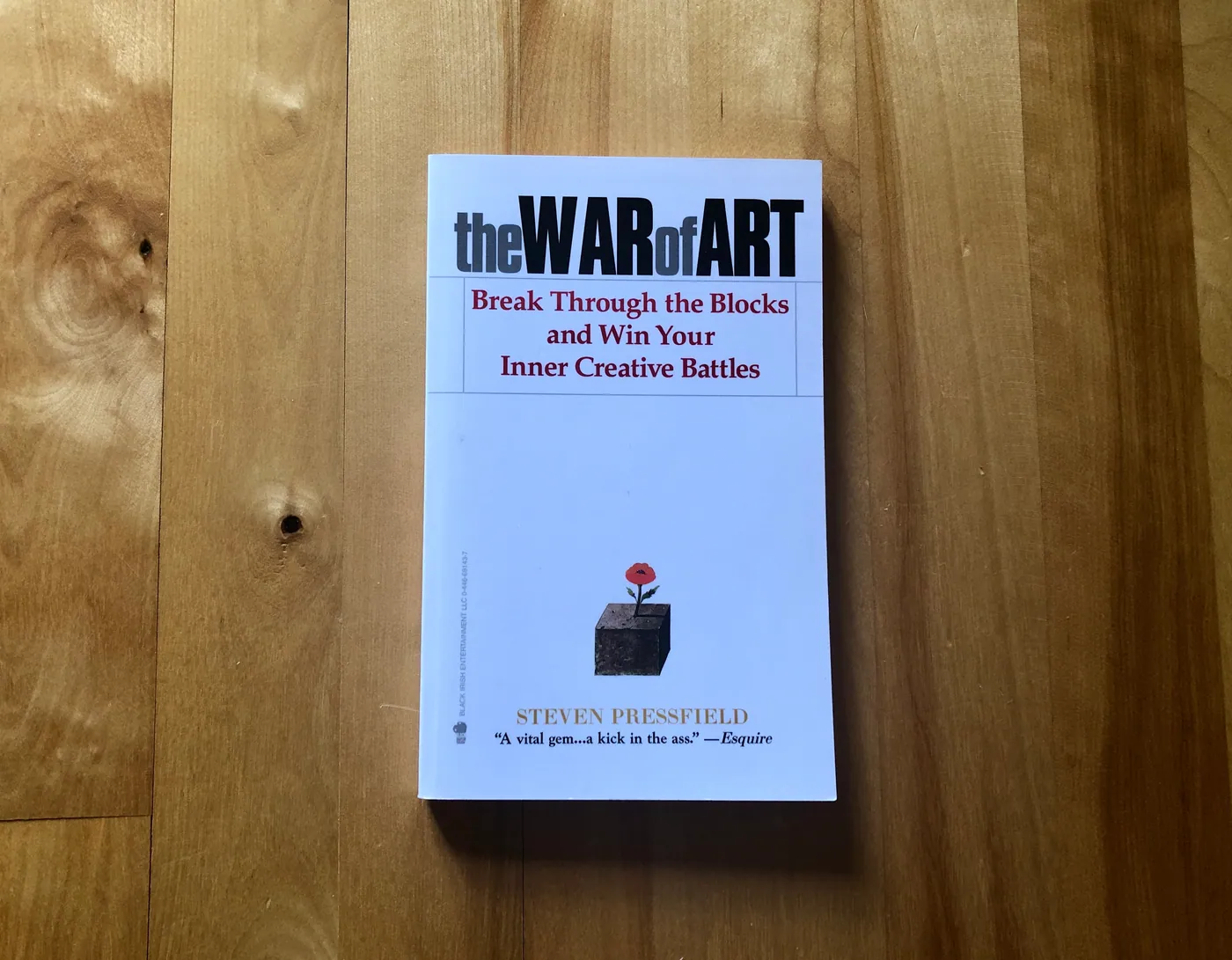 A stack of nonfiction craft-of-writing books on a shelf.