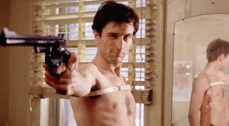 Travis Bickle aiming a revolver at his own reflection in the iconic "You talkin' to me?" mirror scene.