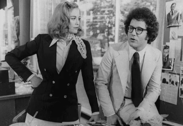 Betsy and Tom standing together in the campaign office, in a black-and-white photo.