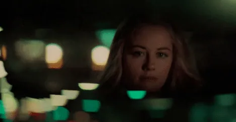 Betsy sitting in the back of Travis's cab at night in the film's final reunion scene, city lights reflected around her.