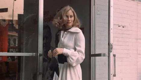 Betsy, in a white coat, exiting the Palantine campaign headquarters.